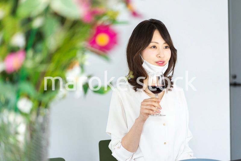 マスクをしてお酒を飲む若い女性