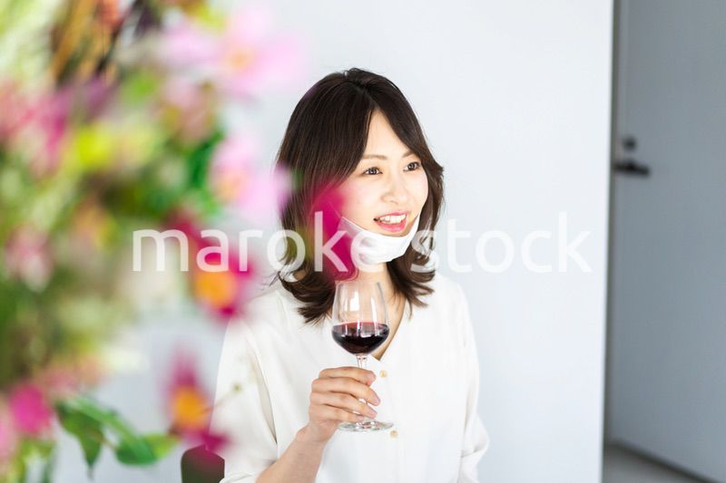 マスクをしてお酒を飲む若い女性