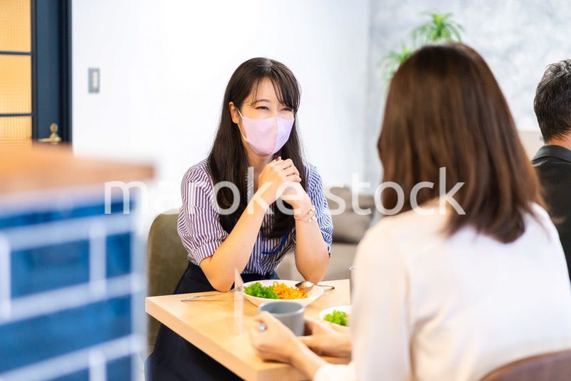 マスクをしてランチをする2人の若い女性