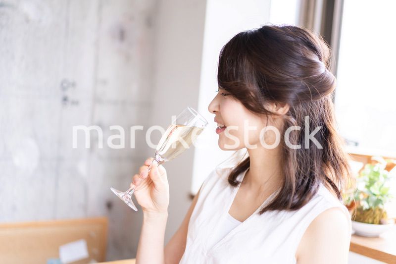 スパークリングワインを飲む若い女性