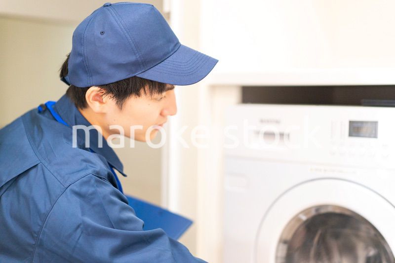 住宅の点検をする作業服の男性