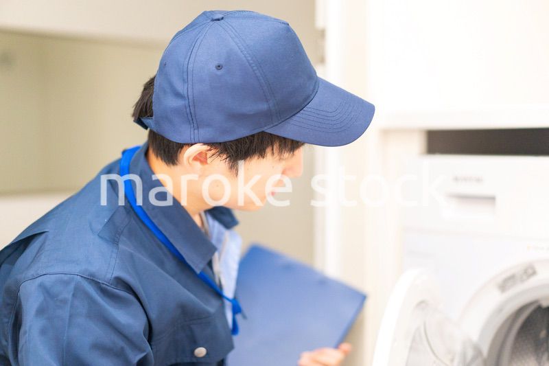 住宅の点検をする作業服の男性