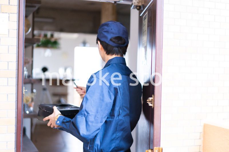 箱を配達する男性の配達員