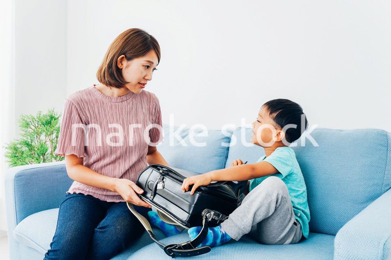 家でお母さんと話す小学生の男の子