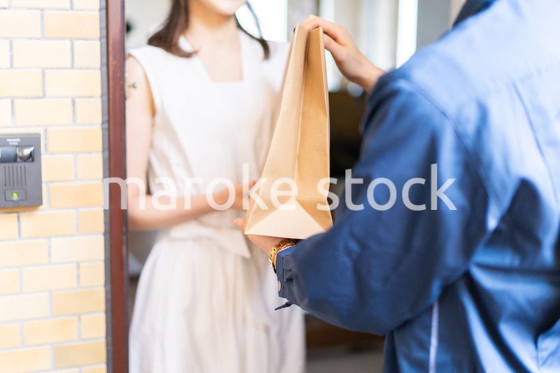 フードデリバリーを受け取る若い女性