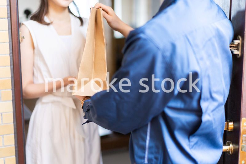 フードデリバリーを受け取る若い女性