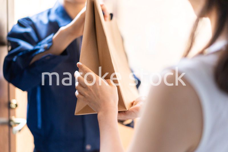 フードデリバリーを受け取る若い女性