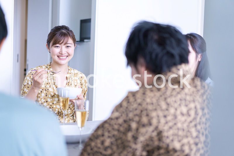 みんなで食事をする若い男女