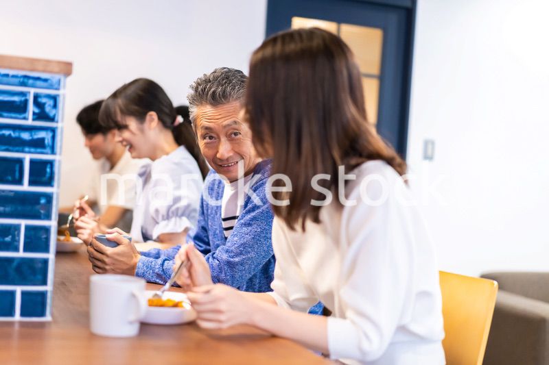 レストランのカウンター席でご飯を食べる人々