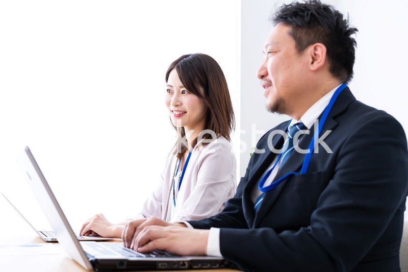 オフィスでデスクワークをする上司と部下