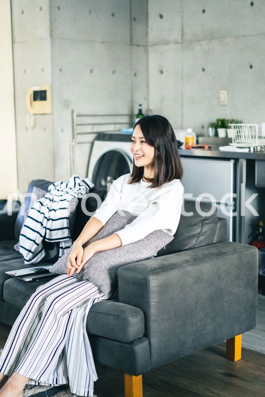 家でテレビを視聴する若い女性