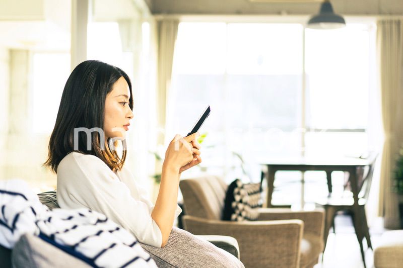 家でテレビを視聴する若い女性