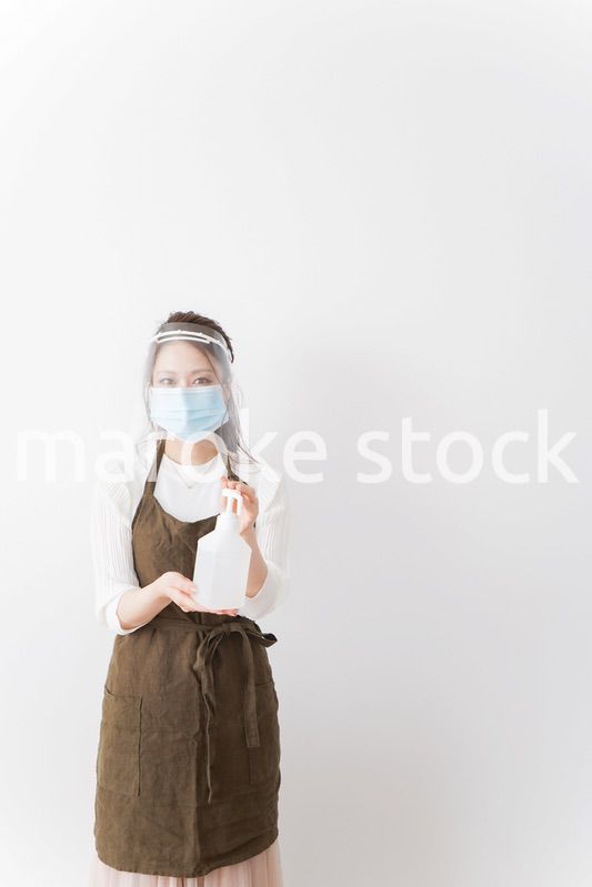 アルコール消毒液を差し出すカフェスタッフ