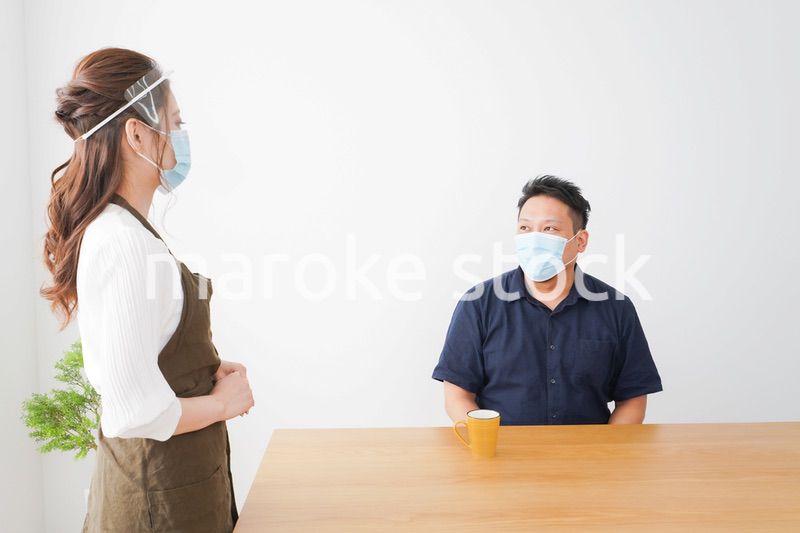 コロナウイルスの予防を徹底するカフェスタッフ