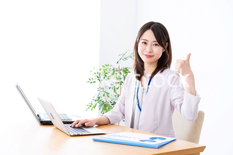 オフィスでグッドサインをする若いビジネスウーマン