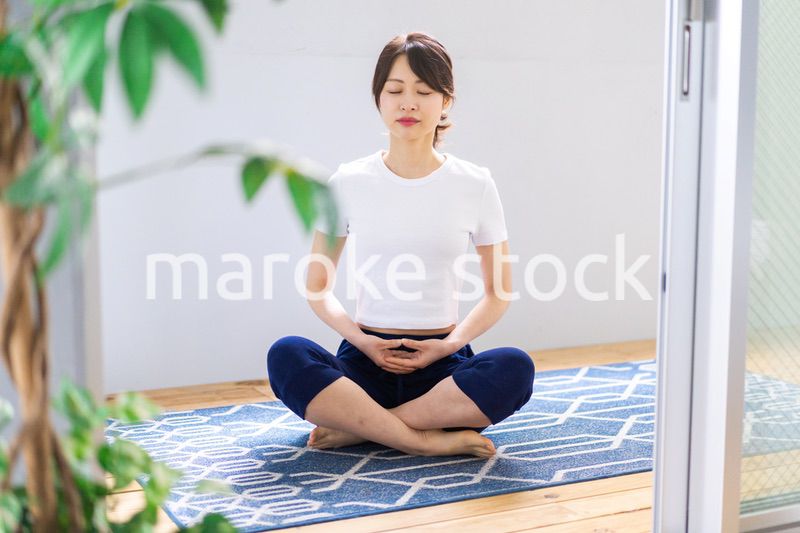 おうちでヨガをする若い女性