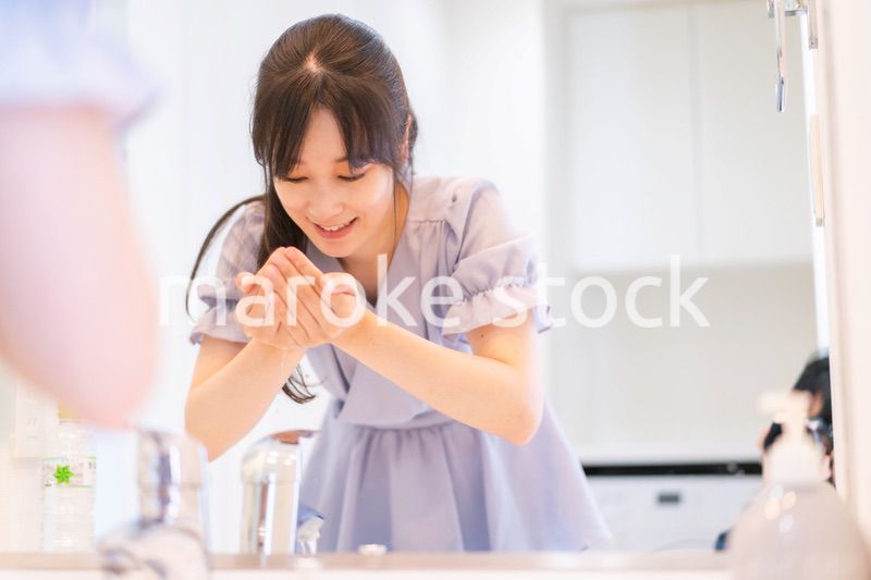 家で洗顔をする若い女性