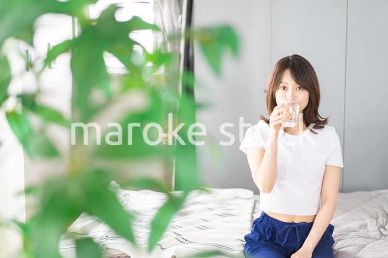 起きて水分補給をする若い女性