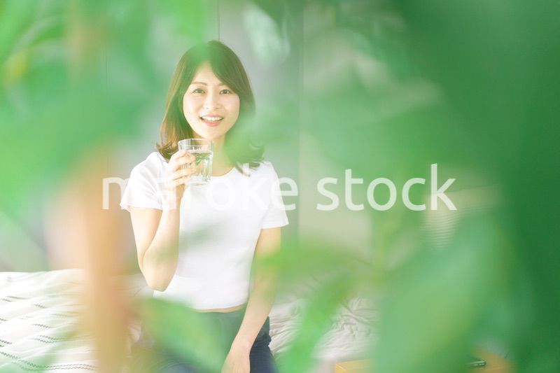 起きて水分補給をする若い女性