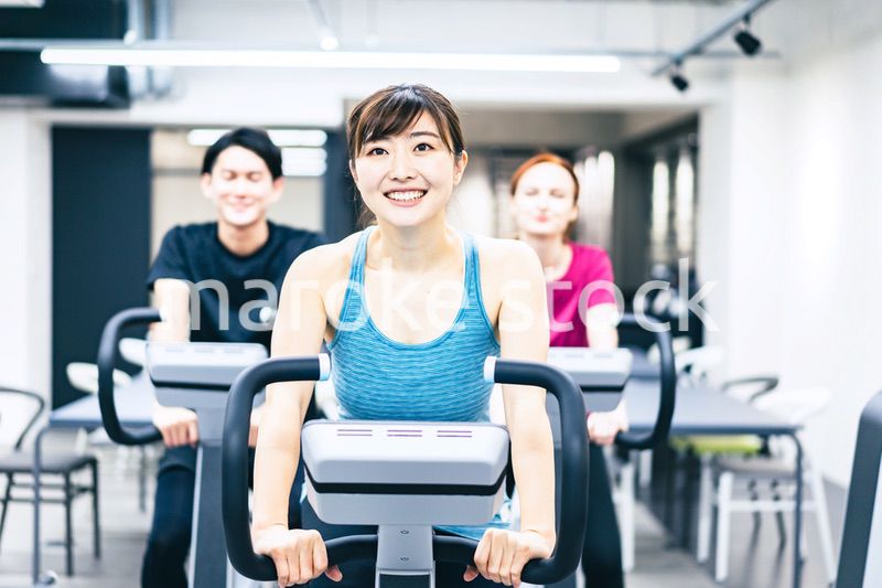 自転車マシンでトレーニングをする人々