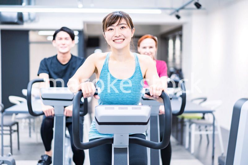 自転車マシンでトレーニングをする人々