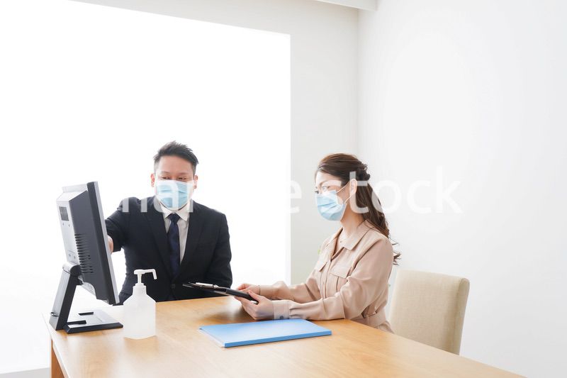 感染症対策をしてオフィスで働くビジネスパーソン
