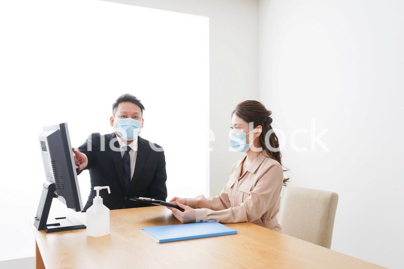感染症対策をしてオフィスで働くビジネスパーソン