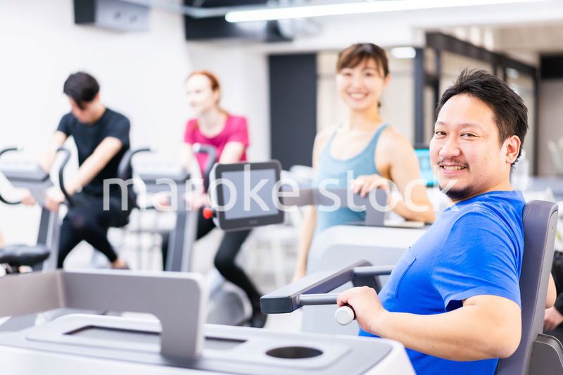 ジムでパーソナルトレーニングを受ける中年男性