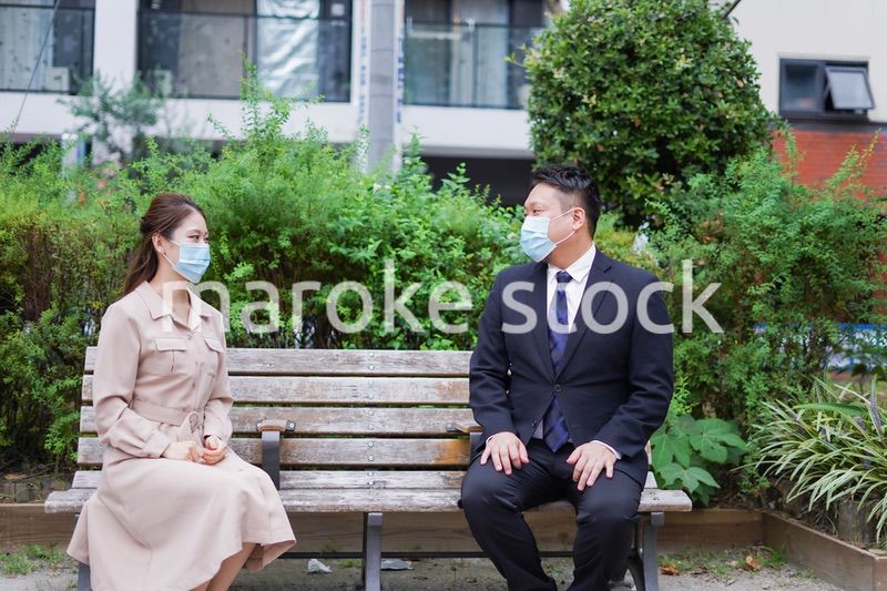 ソーシャルディスタンスを確保して会話をするビジネスパーソン