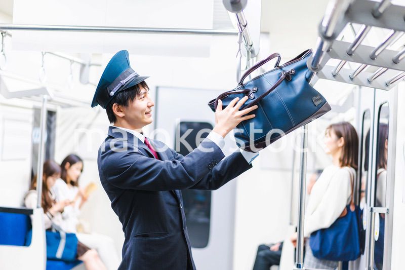 乗客の忘れ物を回収する駅員