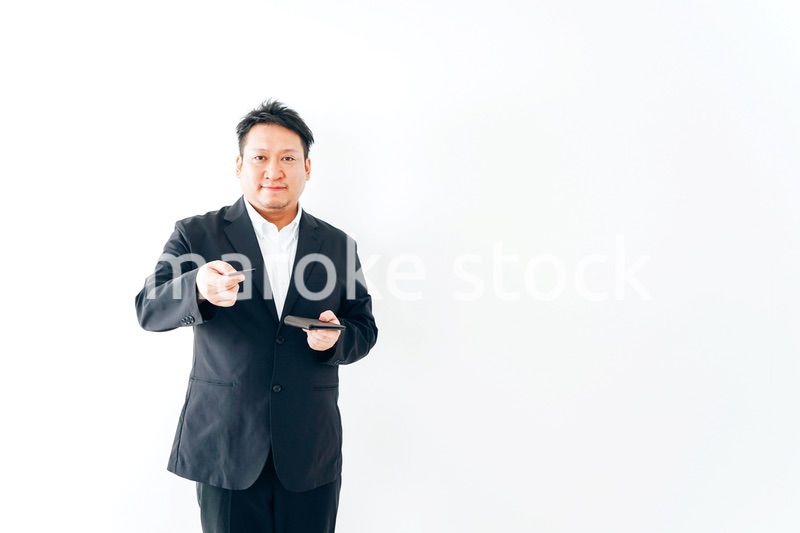 クレジットカード決済をするスーツを着た男性