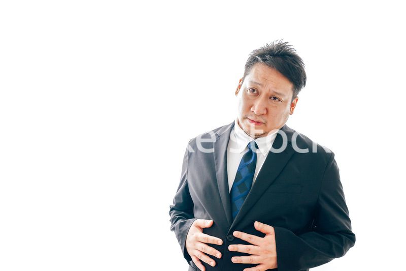 腹痛に苦しむスーツを着た中年男性