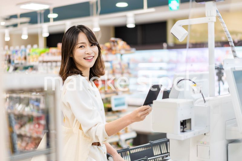 セルフレジ・電子マネー決済をする若い女性