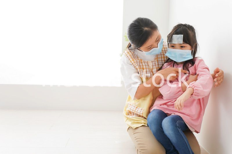 発熱した子供と幼稚園の先生