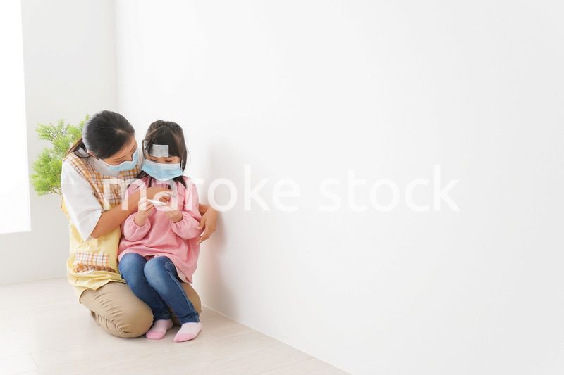 発熱した子供と幼稚園の先生