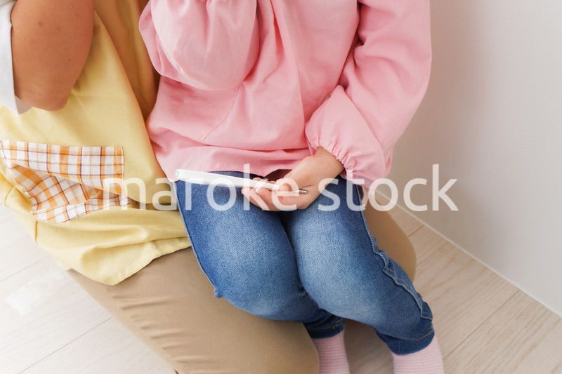 発熱した子供と幼稚園の先生