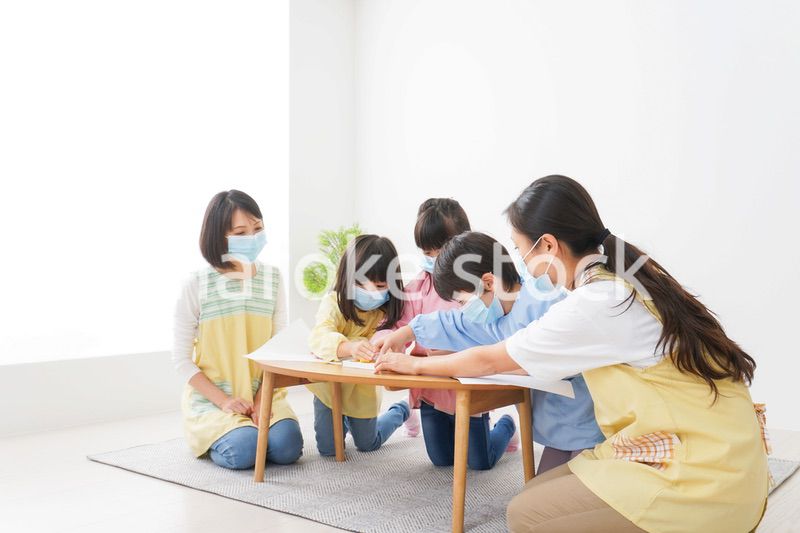 マスクをつけてお絵かきをする幼稚園児と先生