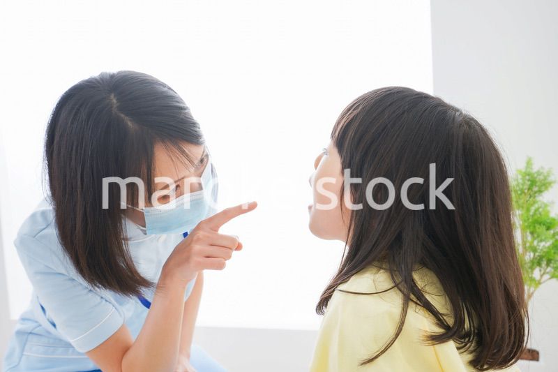 歯医者さんに治療をしてもらう小さな女の子