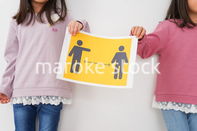 ソーシャルディスタンスの紙を持つ子供