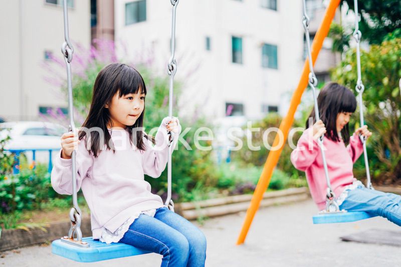 公園で楽しく遊ぶ2人の女の子たち