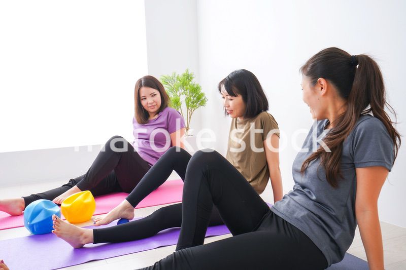 室内でヨガをする女性たち