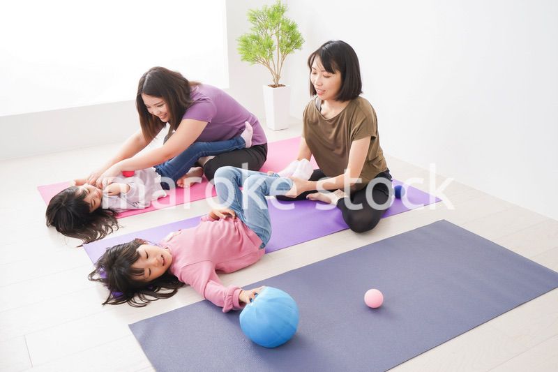 室内でヨガをする子供とお母さん