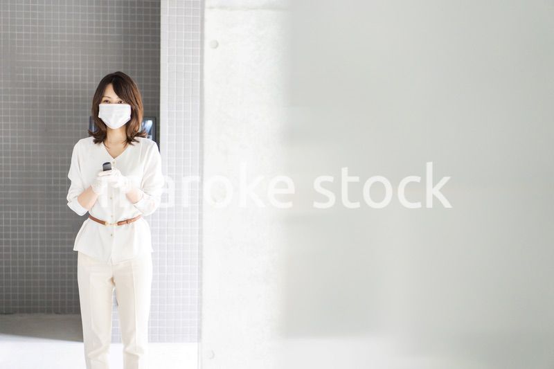 感染拡大防止のためにお客様の体温を計測するスタッフ