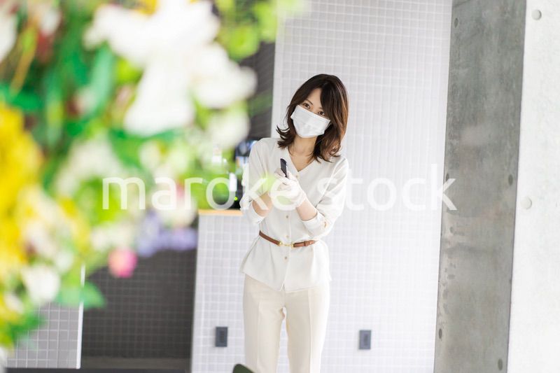 感染拡大防止のためにお客様の体温を計測するスタッフ