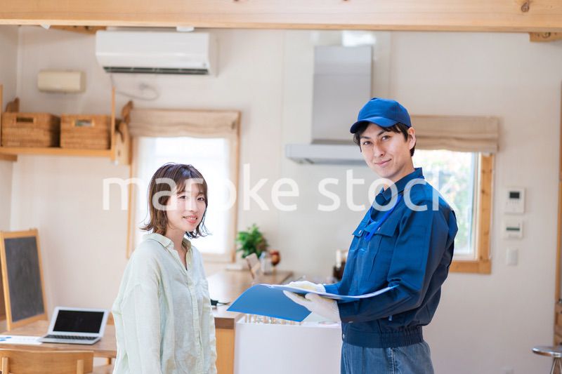 業者に家のメンテナンスをしてもらう女性