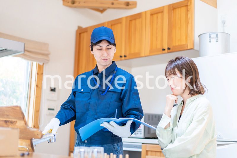 業者に家のメンテナンスをしてもらう女性