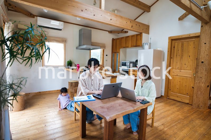テレワークをする大人と家にいる子ども