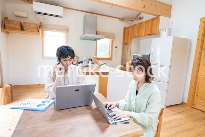 テレワークをする夫婦と子供