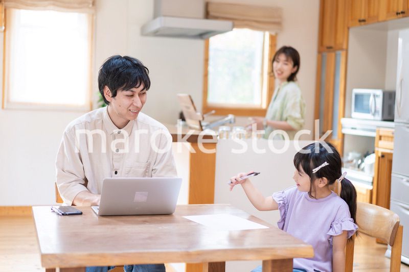 テレワークをする夫婦と子供