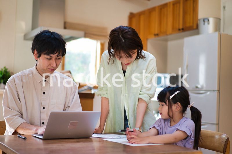 テレワークをする大人と家にいる子ども